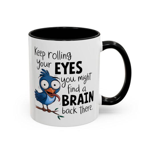 Close-up of ceramic mug featuring bird illustration and phrase