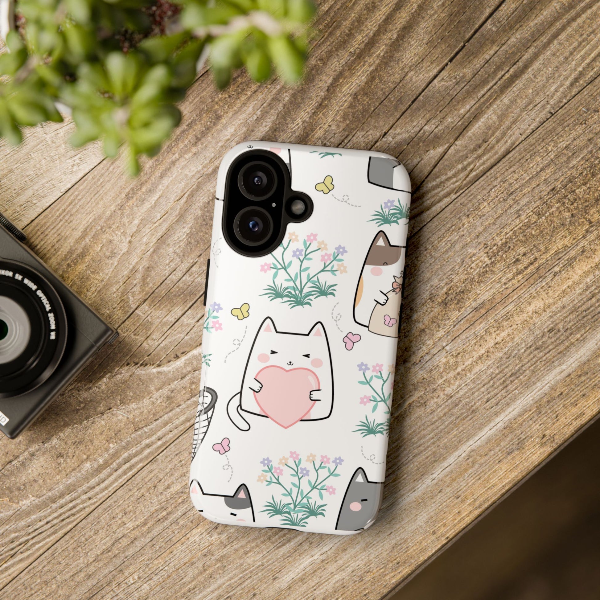 Phone in Cute Cat Floral tough case resting on a desk with cat décor