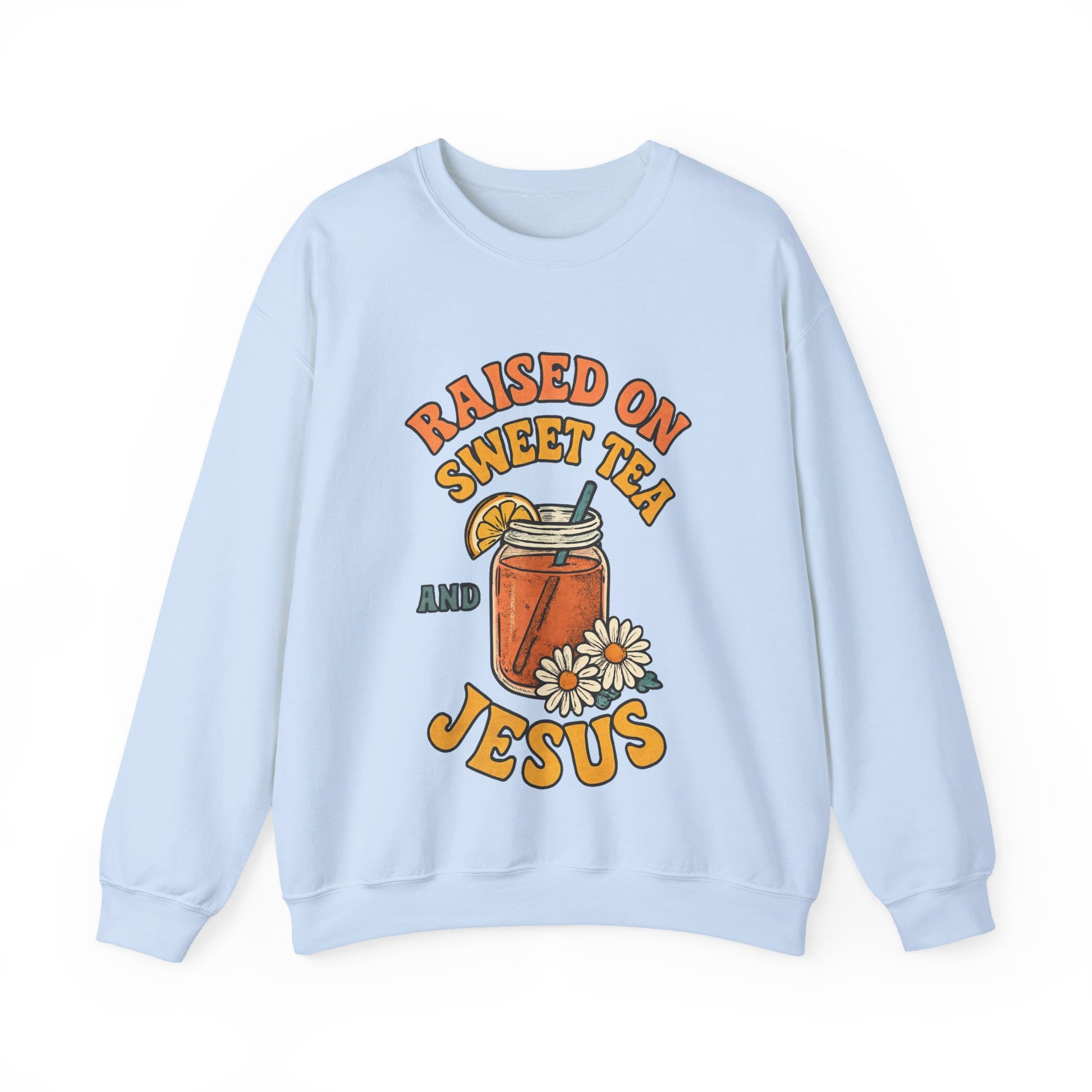Flat lay of Southern Charm crewneck sweatshirt with 'Raised on Sweet Tea & Jesus' graphic on light background